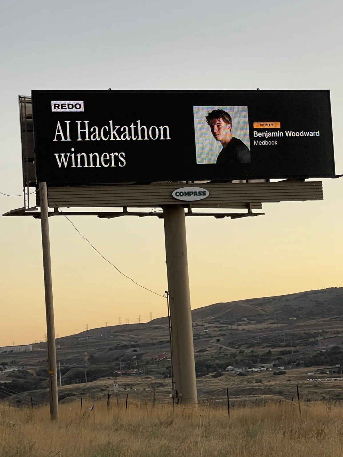 A Redo billboard celebrating a hackathon win.